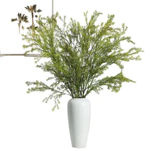 Artificial greenery branches in white ceramic vase for home decor wedding floral arrangement