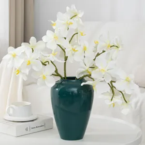 Artificial Phalaenopsis orchid floral arrangement in dark green vase for home decor