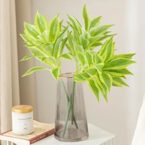 Artificial Dracaena plant in glass vase for indoor home decor, elegant green foliage display.