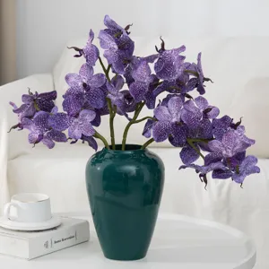 Artificial purple vanda orchid flower arrangement in a dark green vase for home decor