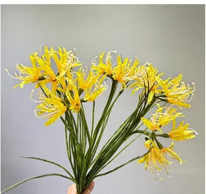 Detailed view of bright yellow artificial spider lily bouquet with green stems for home decor.