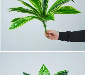 Artificial striped leaf plant branch detail shot, fake foliage floral arrangement stem.