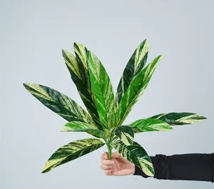 Detailed close-up view of artificial variegated striped green leaves, perfect floral arrangement prop.