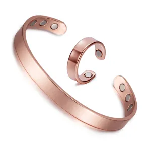 Detail view of the elegant rose gold magnetic copper bracelet and matching ring set closeup.