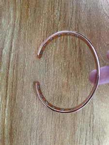 Detail view of the open copper magnetic bracelet showcasing internal magnetic stones clearly.