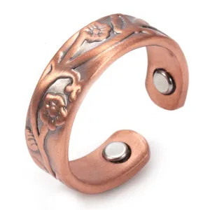 Close-up detail of the embossed floral red copper magnetic open ring showing texture.