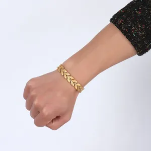 Detail shot of men gold stainless steel magnetic bracelet showing chevron link texture and fit.