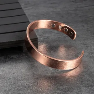 Pure copper plain magnetic cuff bracelet detail shot, elegant polished metallic finish.