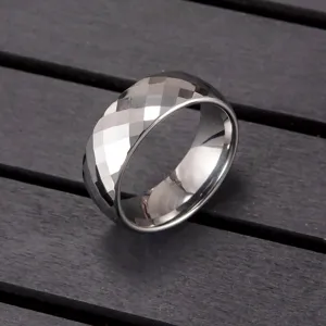 Detailed close-up of the faceted tungsten carbide ring, showing geometric cuts and fine texture.