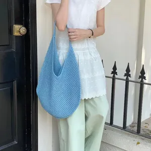 Detail view of the blue crochet hobo bag, large capacity woven tote for women spring summer.