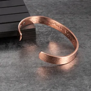 Detail shot of pure copper magnetic cuff bracelet with smooth polished finish and inner magnets.