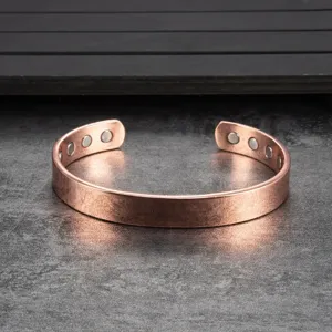 Close-up view of the smooth copper magnetic bracelet detail, showing fine texture and embedded magnets.