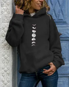 Close-up of black hooded sweatshirt featuring detailed moon phases graphic print and cozy fabric.