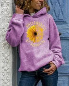 Detailed shot of the casual purple hoodie featuring a sunflower skull print and text.