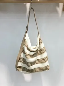 Chic knitted striped shoulder bag for women, stylish underarm hobo bag for summer beach.