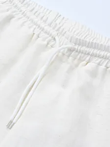 Men's casual shorts detail featuring elastic waistband and white drawstring for comfort.