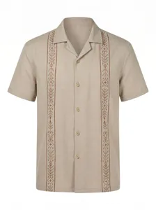 Detailed view of men's short-sleeve shirt featuring intricate brown front embroidery patterns.