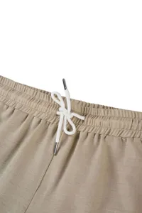 Detailed view of casual men trousers khaki waistband with adjustable white drawstring.