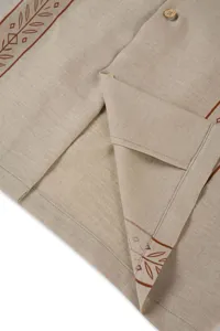 Close-up detail of men's casual printed linen shirt showing fabric texture.