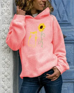 Closeup of casual women hooded sweatshirt showing sunflower and cat graphic chest detail.