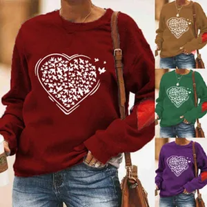 Detailed view of the casual long sleeve sweatshirt showing heart print and elbow patches.