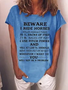 Detailed view of the blue short sleeve t-shirt featuring a funny vintage horse rider quote print.