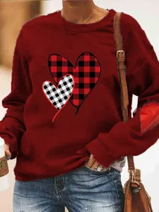 Valentine day red long sleeve crewneck sweatshirt with buffalo plaid heart print and elbow patch.