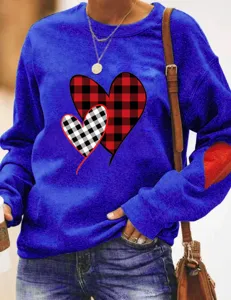 Blue crewneck sweatshirt for women featuring cute buffalo plaid heart prints and elbow patches.