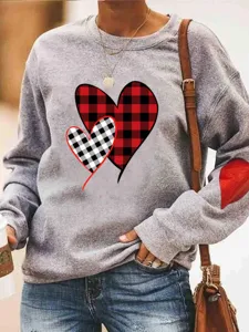 Grey crewneck sweatshirt with red buffalo plaid heart print and elbow patch, casual top.
