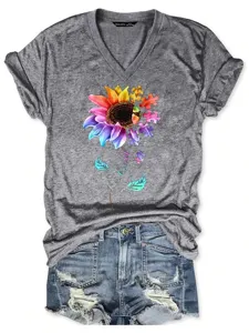 Grey V-neck short sleeve t-shirt with colorful sunflower puzzle graphic and denim shorts.