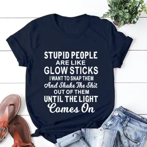 Detailed view of dark blue short sleeve t-shirt with funny quote print on wooden flat lay.