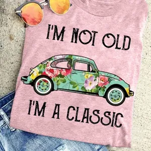 Women vintage graphic tee short sleeve pink t-shirt with classic car print casual top.