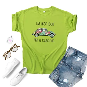 Close-up detail of the vintage car graphic print and slogan on the casual summer green t-shirt.