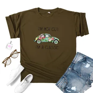 Detailed shot of brown graphic tee featuring vintage floral beetle car and inspiring text print.