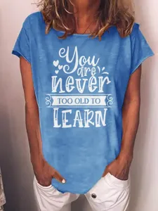 Blue short-sleeve t-shirt detail featuring inspirational typography print on front.