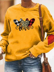 Detailed view of the cute heart print crewneck fleece sweatshirt, showing sleeve heart detail.