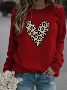 Red crewneck pullover sweatshirt for women featuring a stylish leopard print heart graphic.