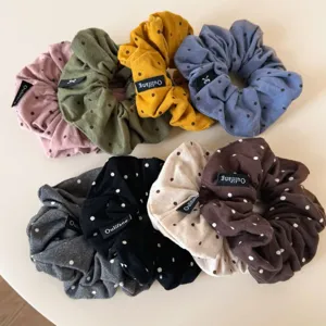 Detailed shot of Korean style pleated polka dot hair scrunchies showing soft fabric and cute design.