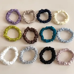 Detailed view showcasing multiple colorful silk satin hair scrunchies, soft and gentle.