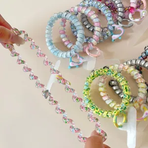 Colorful telephone wire hair tie detail showcasing high elasticity and cute floral charms.