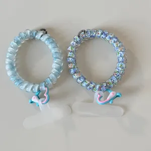 Detailed view of cute telephone wire hair ties with lovely dolphin clips, perfect for daily use.