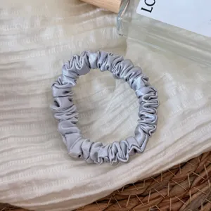 Silver silk satin hair scrunchie, elegant small hair ring accessory for daily ponytail styling.