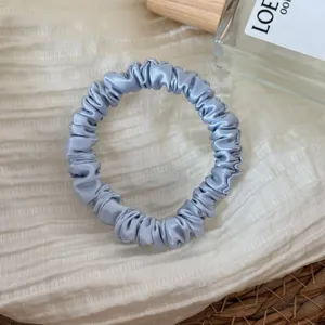 Blue silk satin scrunchie detail shot, elegant small hair accessory for women styling