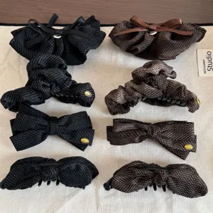 Detailed shot of stylish polka dot mesh hair clips and scrunchies in chic black and brown.