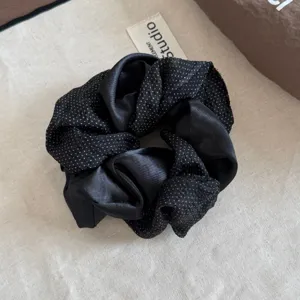 Black polka dot satin scrunchie, elegant hair accessory for women, stylish daily ponytail holder.