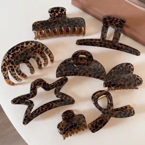 Set di eleganti mollette per capelli leopardate marroni, accessori geometrici in acrilico.
