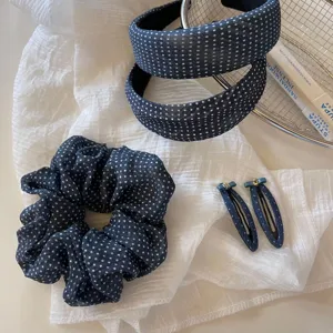 Dark blue polka dot hair accessories set detail showing scrunchies headbands and clips.