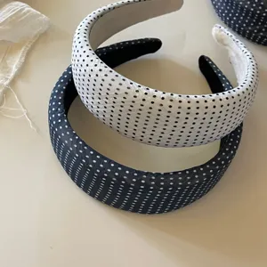 Classic polka dot hair hoop, elegant design, comfortable daily hair accessory item.