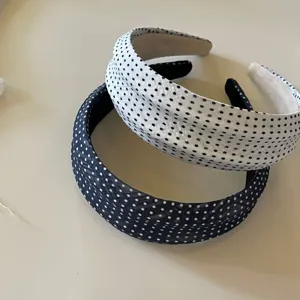 Polka dot headband detail view, showing the classic black and white and navy blue design.