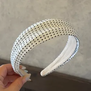 White and black polka dot headband for women, stylish fabric hair hoop accessory for daily wear.